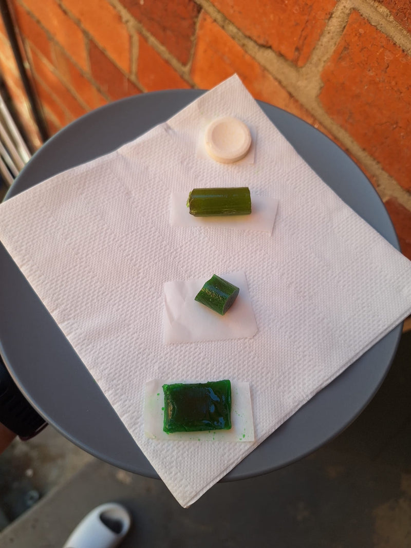 Three early candy formats lined up next to a standard effervescent electrolyte tablet
